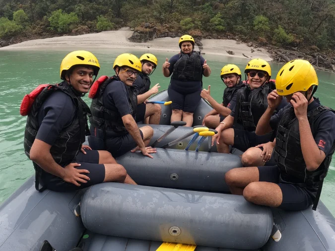 Group enjoying riverside camping with bonfire in Rishikesh