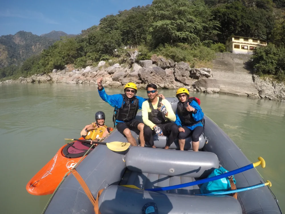 Adventurers navigating rapids during a 24 km rafting trip in Rishikesh